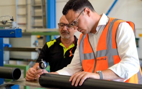 Pipelife's Head of R&D, Konstantinos Akritanakis, inspects a pressure pipe together with a colleague.