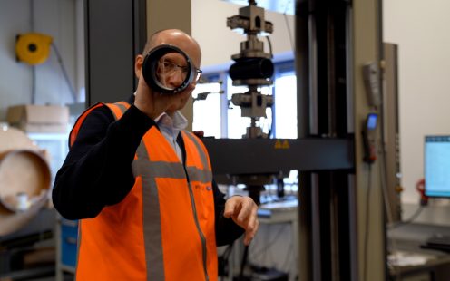 Pipelife's Head of Sustainability, Zoran Davidovski, examines a sample of corrugated pipe, containing recycled material.