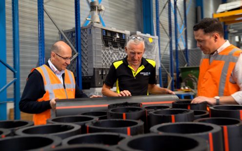 Pipelife's R&D and Sustainability teams examine samples HDPE cable protection pipes containing recycled material.