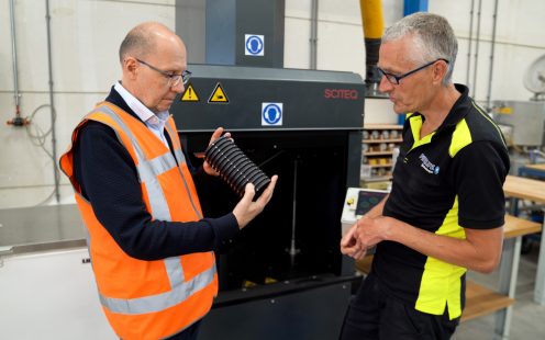 A corrugated plastic pipe with recycled content is being examined at Pipelife's R&D department.