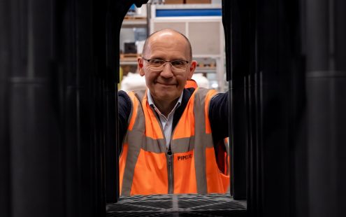 Pipelife's Head of Sustainability, Zoran Davidovski, standing behind stacked Stormbox II E crates, made from 100% recycled PP.