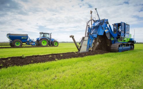 Field drainage system installation machinery working on a field