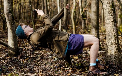 A young guy leaning back to take a photo of a tree from an unusual angle | Pipelife 