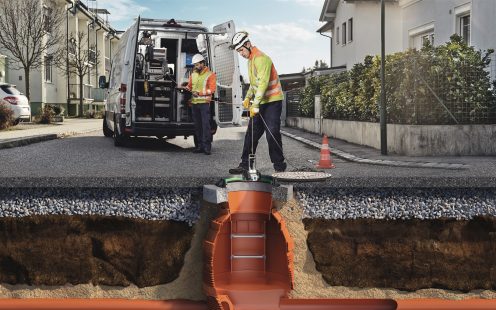 two men inspecting wastewater system