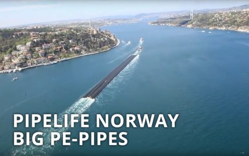 Long length pipes being delivered by the water