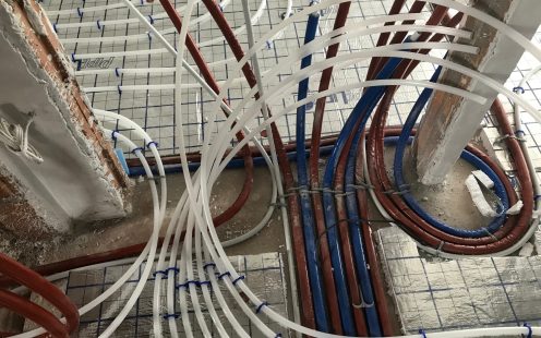 Hot and cold water supply pipes together with hydronic underfloor heating pipes at a construction site in Bulgaria | Pipelife