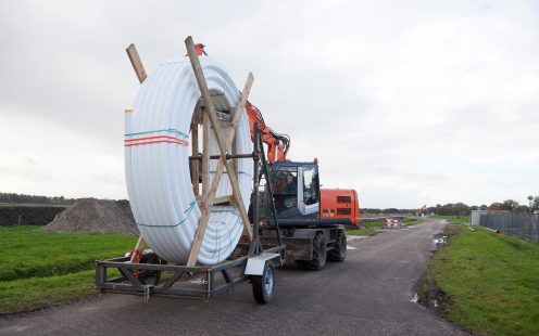 A tractor transporting a coiled SoluForce pipe | Pipelife