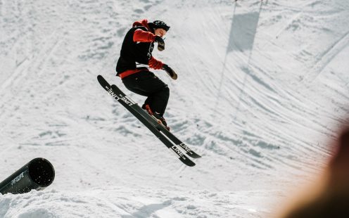 A skier performs a jump above two rails made from HDPE pipes | Pipelife