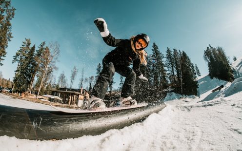 A young girl on a snowboard sliding over a Pipelife rail in Baldone | Pipelife