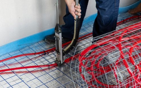 Martin installing the prefabricated underfloor heating mats in his house | Pipelife