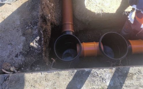A shallow open trench with a Pragma pipe laid and connected to two inspection chambers | Pipelife