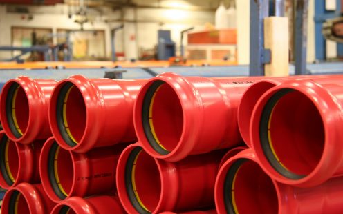 Cable protection tubes red, in production hall