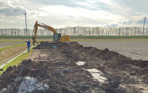 An excavator digging a trench at Klaas' field to close the existing drainage system | Pipelife