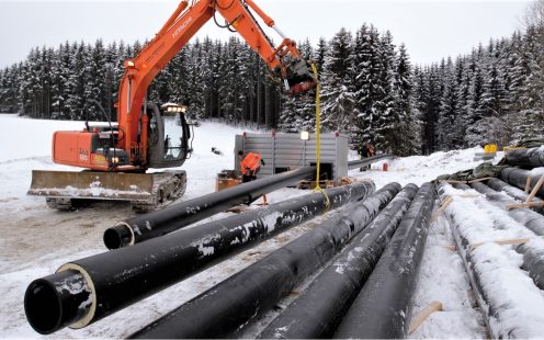 An excavator next to several pre-insulated Isovarm pressure pipes | Pipelife