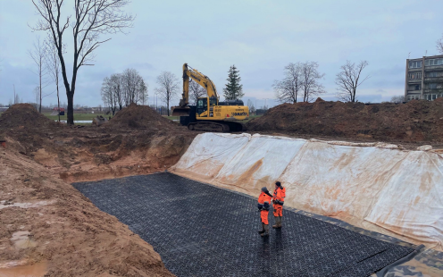 Two installers standing atop the completed stormwater reservoir in Ukmerge | Pipelife