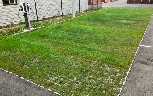 Permeable paving blocks, filled with a soil-sand mixture and planted with vegetation for parking lots