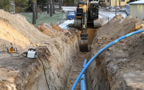 An excavator digging out a trench to install the new water line | Pipelife