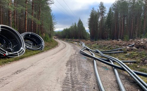 Coiled and uncoiled cable protection pipes at the installation site | Pipelife