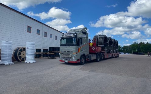 A truck loaded with several coils of cable protection pipes | Pipelife