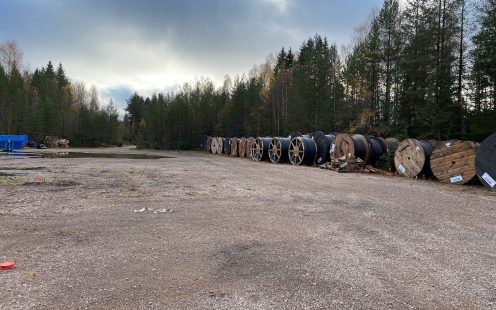 Coiled cable protection pipes from 100% recycled PE at an empty parking lot nearby the project site | Pipelife