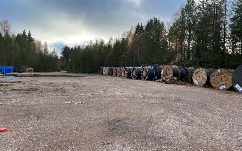 Coiled cable protection pipes from 100% recycled PE at an empty parking lot nearby the project site | Pipelife