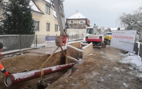 A PP Master pipe is being lowered into a narrow trench in St.Peter/Au | Pipelife