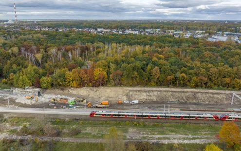 An aerial photo of the LK7 line with a red train moving and construction works taking place nearby the railway | Pipelife