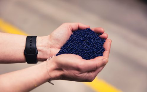 Hands holding plastic granules
