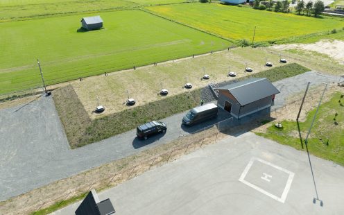 An aerial photo showing the installation site covered by grass in summer after the works have been completed.