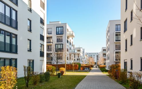 White, modern apartment buildings in a green residential area in the city | Pipelife