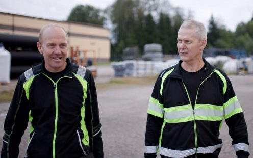 Senior Production Specialists Jan Hellberg and Bo Johansson walking through the open storage area at the Ölsremma plant.