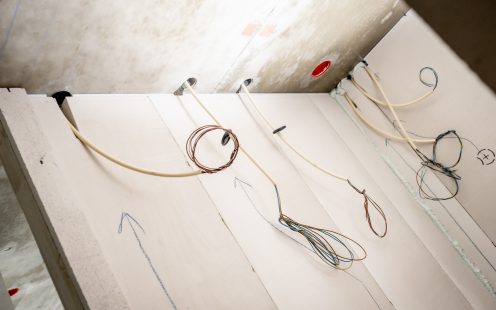 A concrete wall structure with several integrated conduits.
