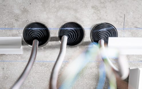 Close-up of three ceiling boxes integrated in a concrete slab.