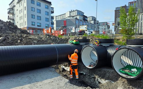 An installer standing next to one of the five inspection chambers of the reservoir.